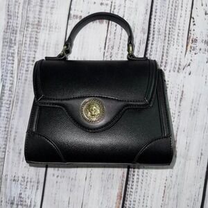 Aldo Black leather crossbody bag with gold lion hardware and chain strap